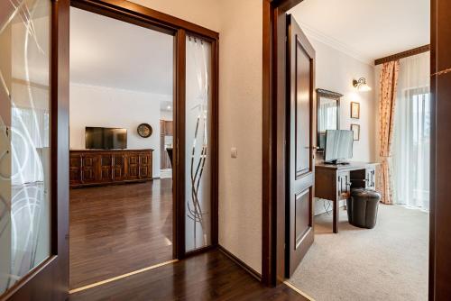 a hallway with a door leading to a living room at Hotel Regal in Sinaia