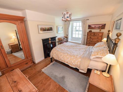 a bedroom with a bed and a fireplace at Corner House in Lorton