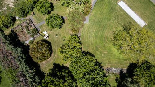 an overhead view of a field with trees and a house at Chalet Eiger in Taupo