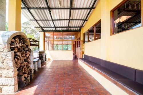 a hallway of a building with a brick floor and a ceiling at Cabaña de Hacienda Nebraska in Zipacón