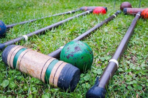 a group of baseball bats laying on the grass at Cabaña de Hacienda Nebraska in Zipacón