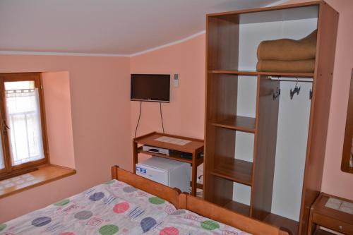 a bedroom with a bed and a book shelf at Sobe Pintur in Grožnjan