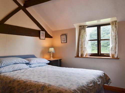 a bedroom with a large bed and a window at Halford Big Barn in Halford