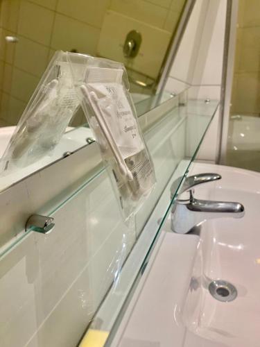 a bathroom with a white sink and a mirror at Beach Class Executive in Recife