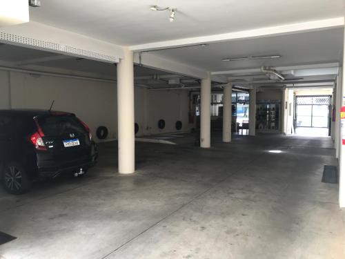 a parking garage with a car parked in it at Pousada Soares in Aparecida