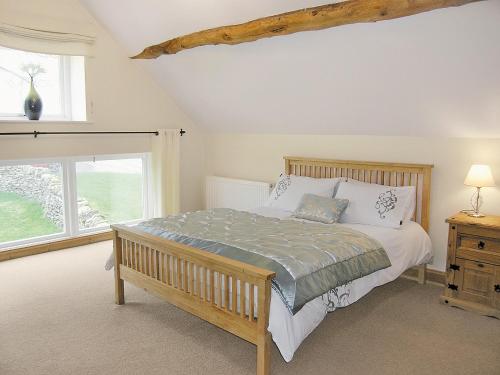 a bedroom with a bed and a window at Pasture Barn in Lockton