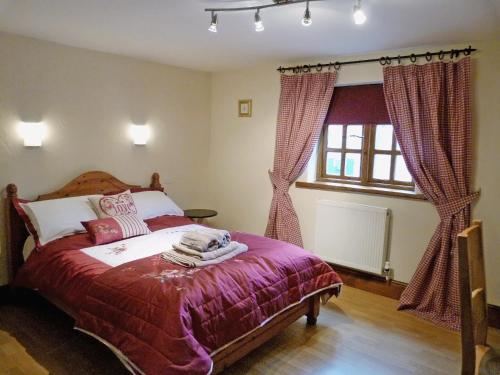 a bedroom with a bed and a window at The Stables in Hornsea