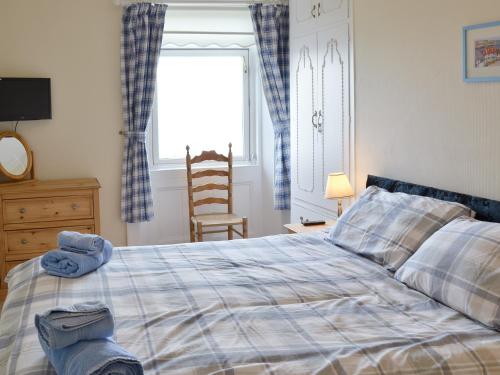a bedroom with a bed with a blue towel on it at Sea Views in Filey