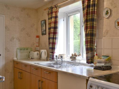a kitchen with a sink and a window at Rannoch in Saint Fillans