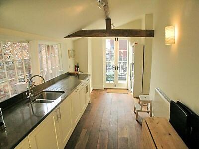 a kitchen with a sink and a wooden floor at Crown And Anchor in Wells next the Sea