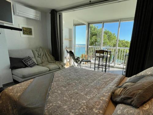 a living room with a couch and a large window at Vacances paradisiaques, Plage Cannes boccacabana, studio in Cannes