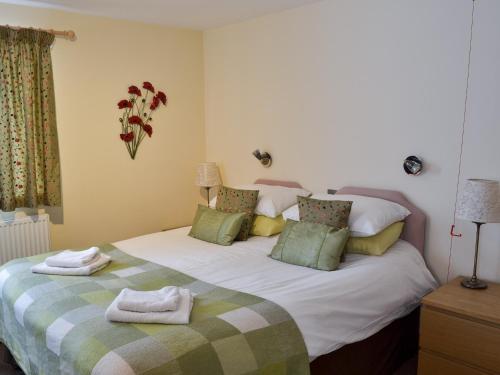 a bedroom with a large bed with towels on it at The Stable in Burscough