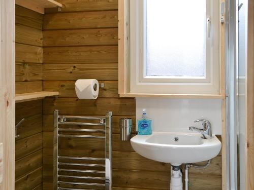 a bathroom with a sink and a window at Treehouse Cabin in Westward
