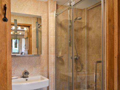 a bathroom with a shower and a sink at Little Timbers in Woodmancote