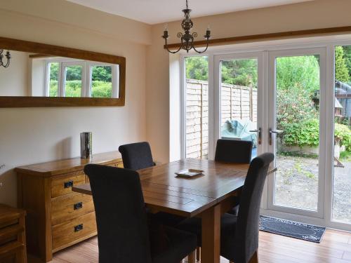 a dining room with a wooden table and chairs at Ivy Cottage in Kielder