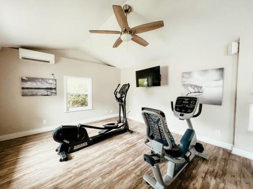 a gym with two exercise bikes and a ceiling fan at Bayside Inn Key Largo in Key Largo