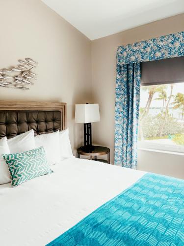 a bedroom with a bed and a window at Bayside Inn Key Largo in Key Largo