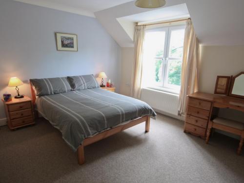 a bedroom with a large bed and a window at Ty Gwyn - Hw7322 in Haverfordwest