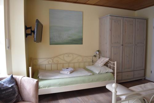 a bedroom with a bed and a large cabinet at Kreativhof Lehmberg in Hamminkeln