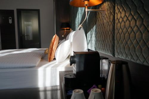 a bedroom with a bed and a lamp on a table at Boutique Hotel Germania in Munich
