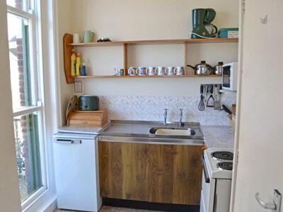 a small kitchen with a sink and a stove at Bounty in Cromer