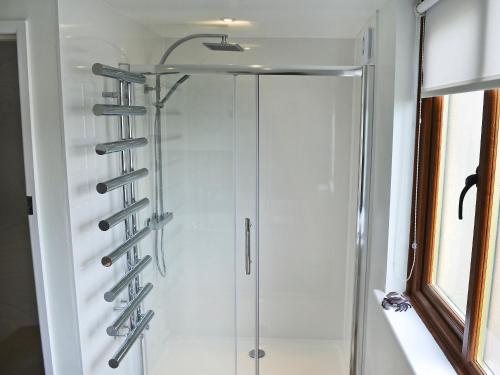a shower in a bathroom with a glass shower stall at Dover Row Cottage in Zelah