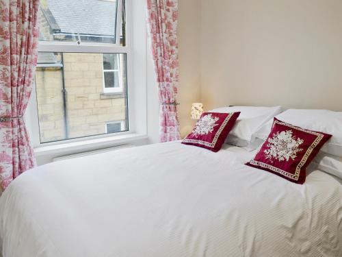 A bed or beds in a room at Rosehip Cottage