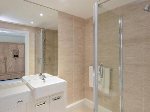 a bathroom with a sink and a shower at Property 1 in Wroxall