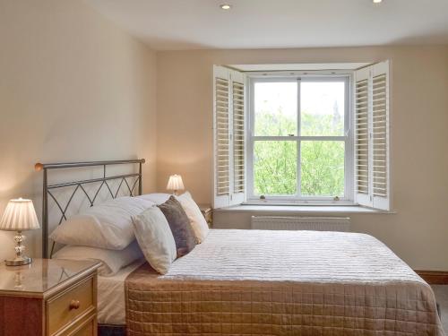 a bedroom with a bed and a window at Church View in Ambleside