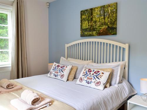 a bed with pillows on it in a bedroom at Chesnut Cottage - 27524 in Sewerby