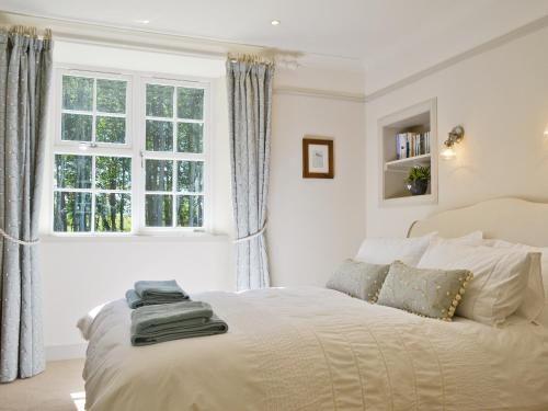 a bedroom with a bed and a window at Curlew Cottage in Meigle