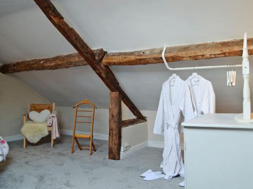 a room with white clothes hanging on a wall at The Cider Barn in Presteigne