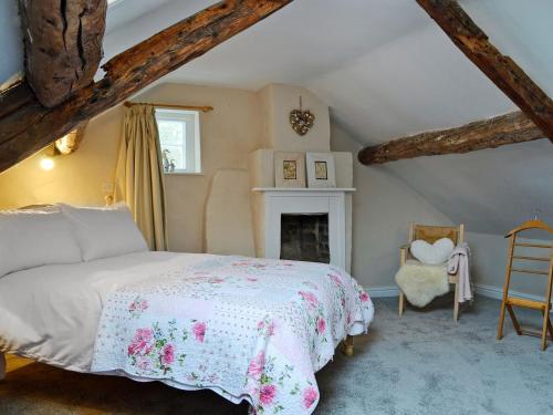 a bedroom with a bed and a fireplace at The Cider Barn in Presteigne