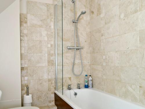 a bathroom with a shower with a tub and a toilet at Rose Cottage in Chipping Campden