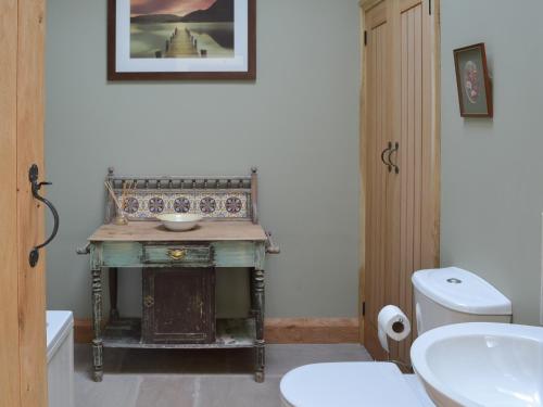 a bathroom with a sink and a toilet at Brow View Cottage in Ravenstonedale