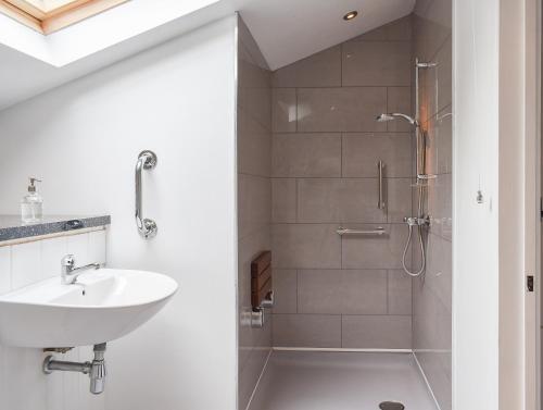 a bathroom with a sink and a shower at The Granary in Oxborough