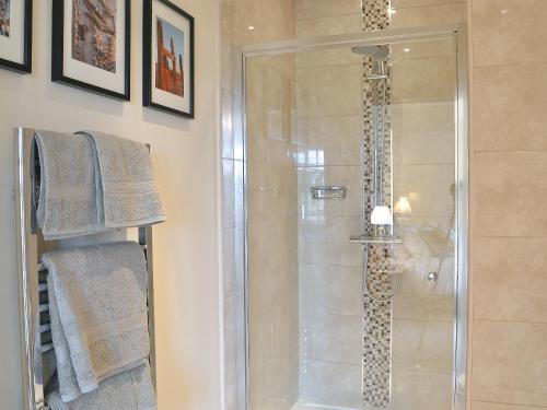 a shower with a glass door in a bathroom at Tudor House in Eastrington