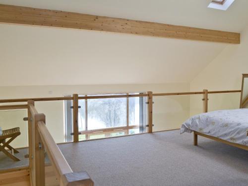 a bedroom with a bed and a balcony at Orchid Lodge in Hainford