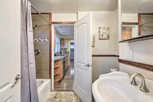 a white bathroom with a tub and a sink at Port Angeles Retreat - 1 Mi to Downtown! in Port Angeles