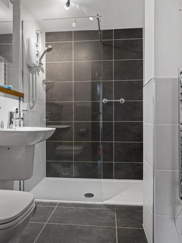 a bathroom with a shower with a toilet and a sink at Entire holiday home with FREE parking & fast WIFI in Ambleside