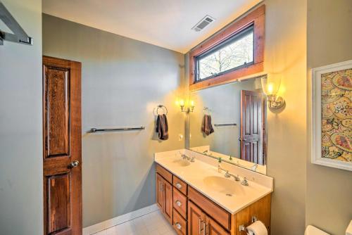 a bathroom with a sink and a mirror at Lakefront Harrison Home with Sunroom, Deck, and Dock! in Ooltewah