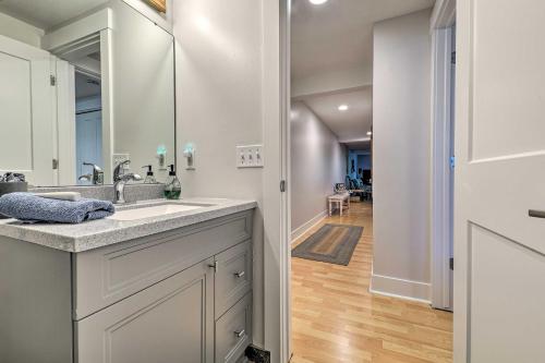 a bathroom with a sink and a mirror at Downtown Grand Haven Apt Less Than 1 Mi to Lake Michigan in Grand Haven