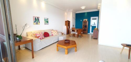 a living room with a white couch and a table at Perfect views best location in Rio de Janeiro