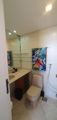 a bathroom with a toilet and a sink and a mirror at Perfect views best location in Rio de Janeiro