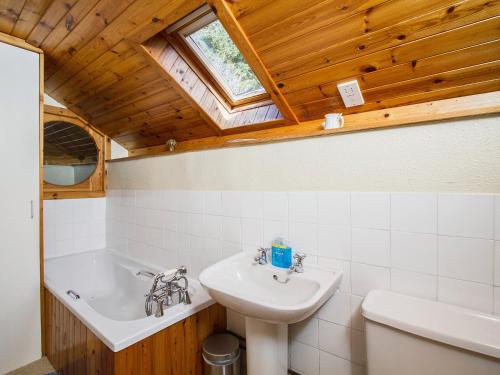 een badkamer met een wastafel, een toilet en een bad bij The Old Laundry in Balnaboth