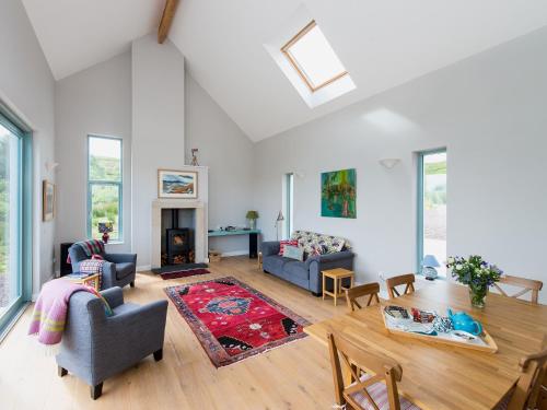 a living room with a couch and a fireplace at Tigh An Iasgair in Fearnmore