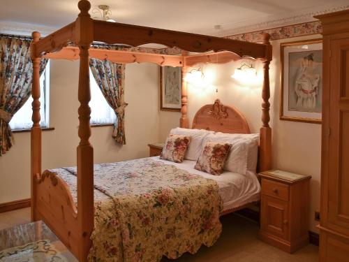 a bedroom with a four poster canopy bed at Pheasant Roost in Swanton Morley