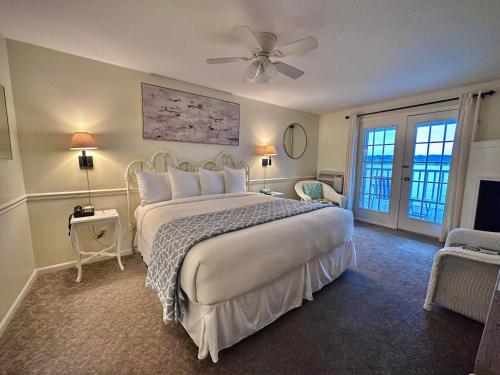 a bedroom with a large bed with a ceiling fan at The French Country Inn in Lake Geneva