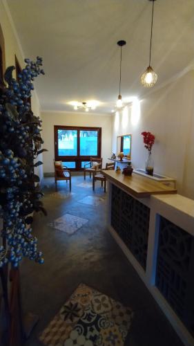 a living room with a fireplace and a christmas tree at Parcel do Gostoso Pousada in São Miguel do Gostoso