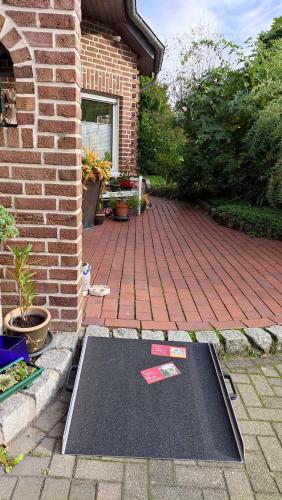 a mat on the ground in front of a brick house at Kreativhof Lehmberg in Hamminkeln